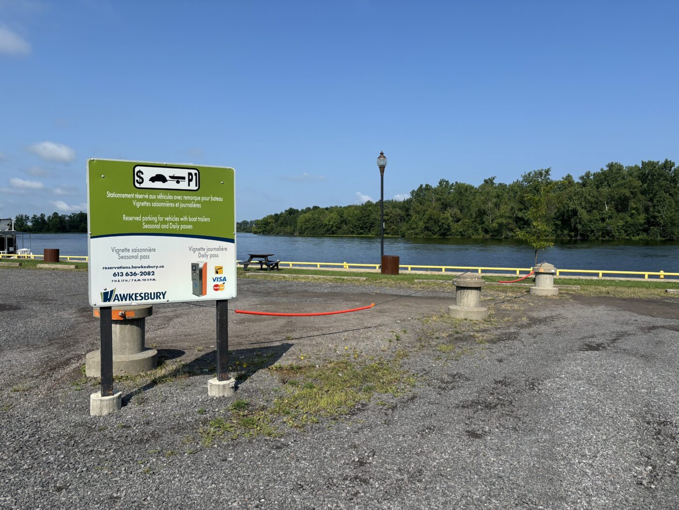 Photo of Confederation Park's parking lot with information sign.