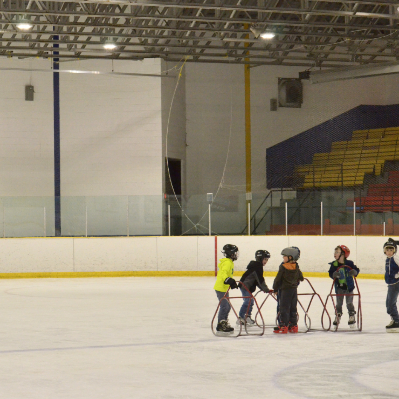 Photo of children skating on an indoor rink.