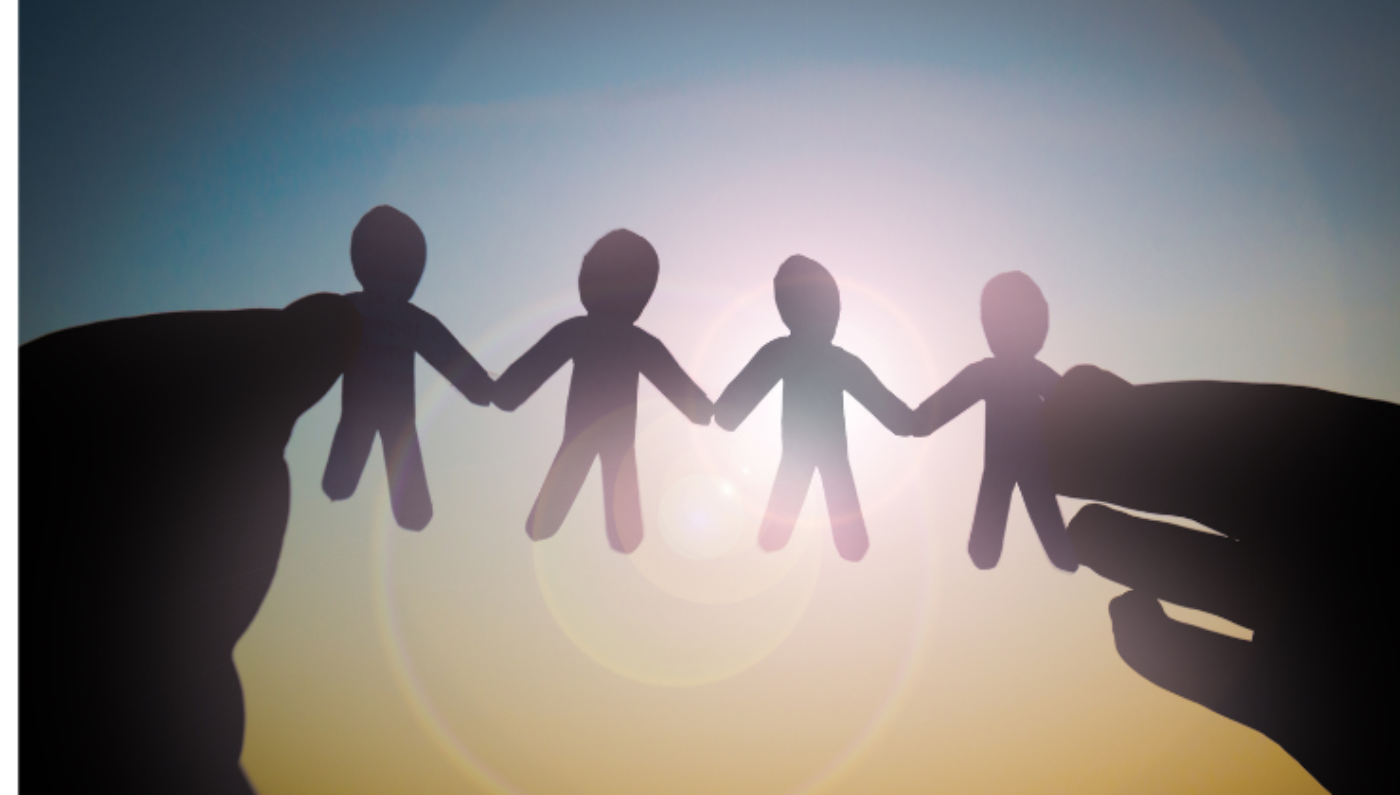 Generic image of two hands holding paper cut into four person holding hands