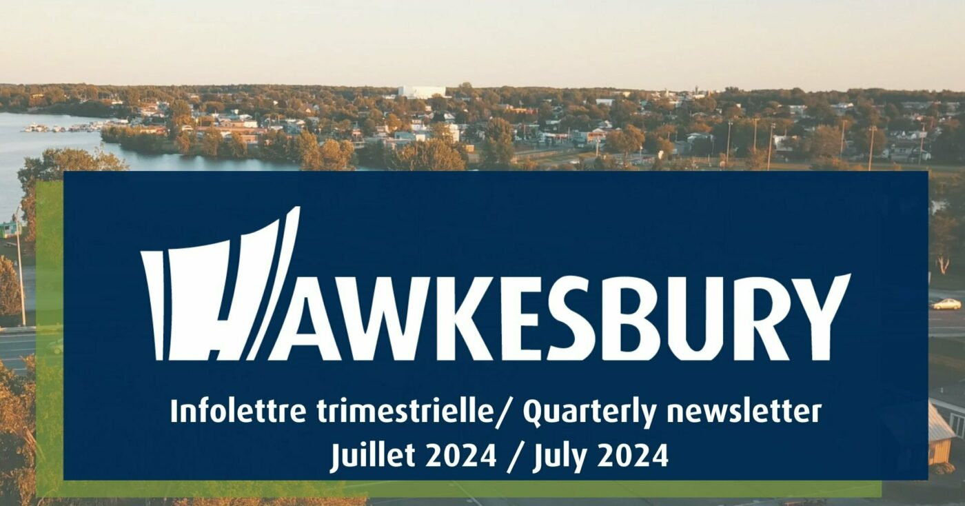 Aerial photo of the Town of Hawkesbury with a sign featuring the white town logo and the text ‘'Quarterly newsletter July 2024’' in French and English.