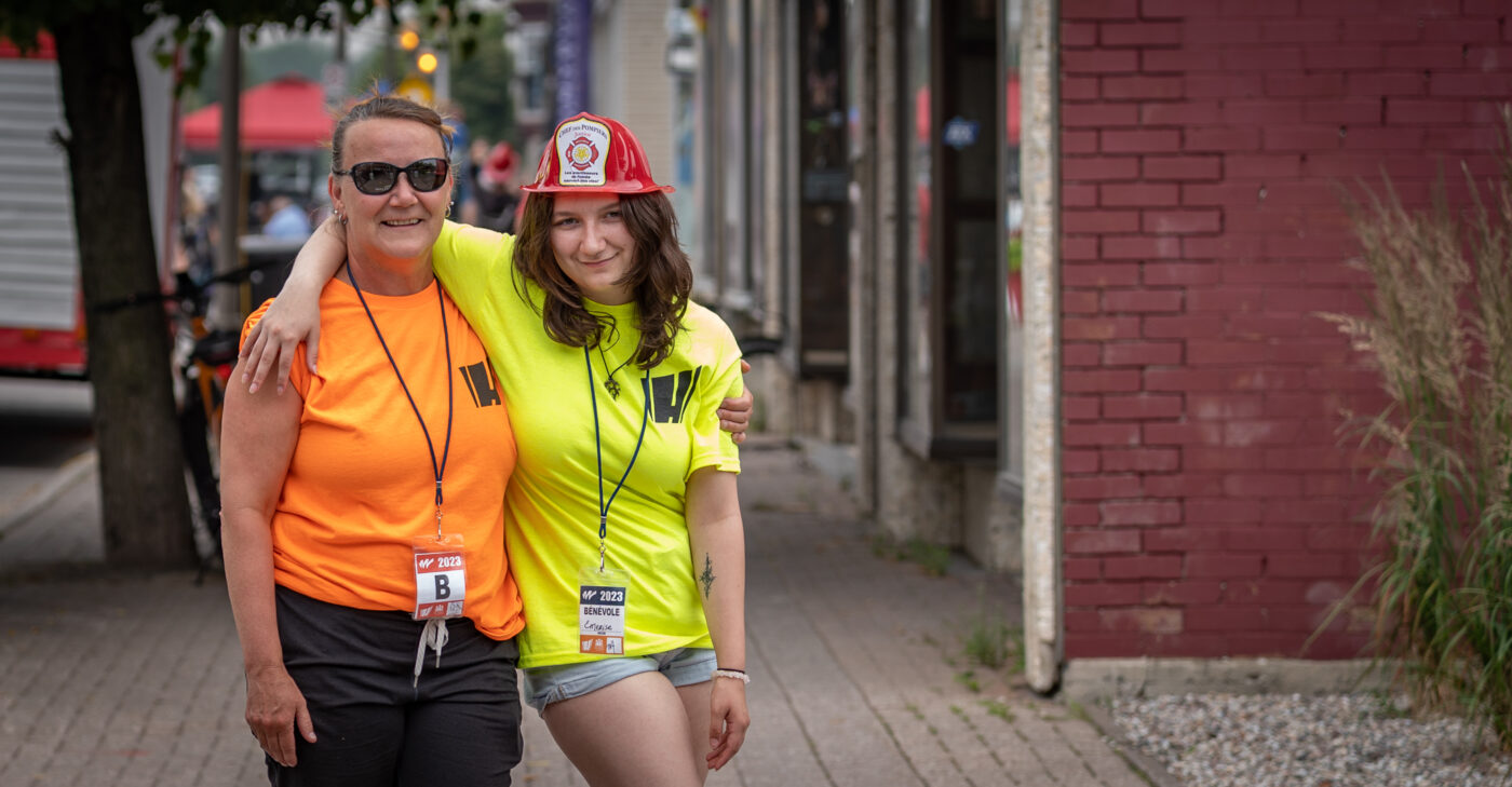 Photo of two Town of Hawkesbury volunteers arm in arm