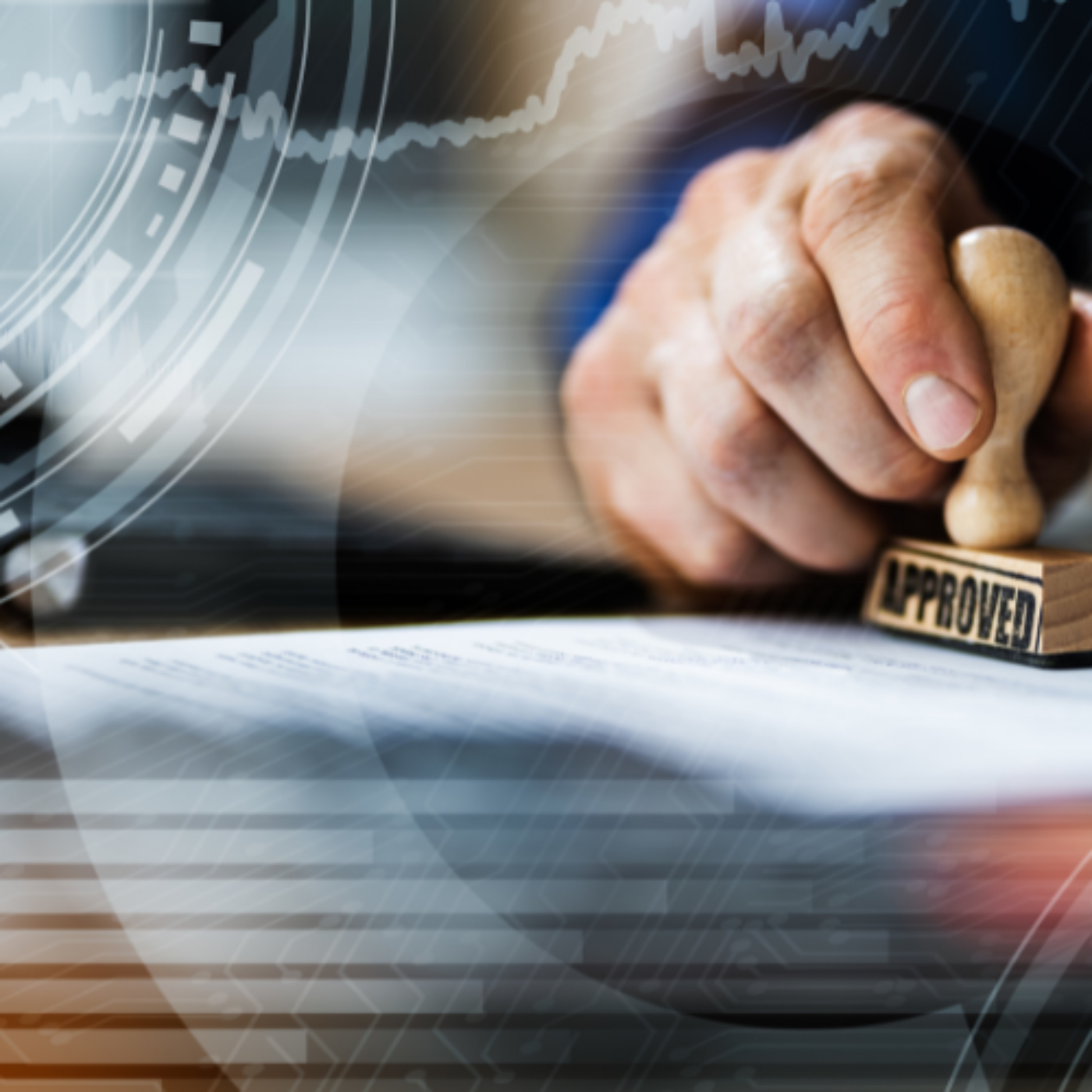 Close-up of a hand affixing an “approved” stamp to a document.