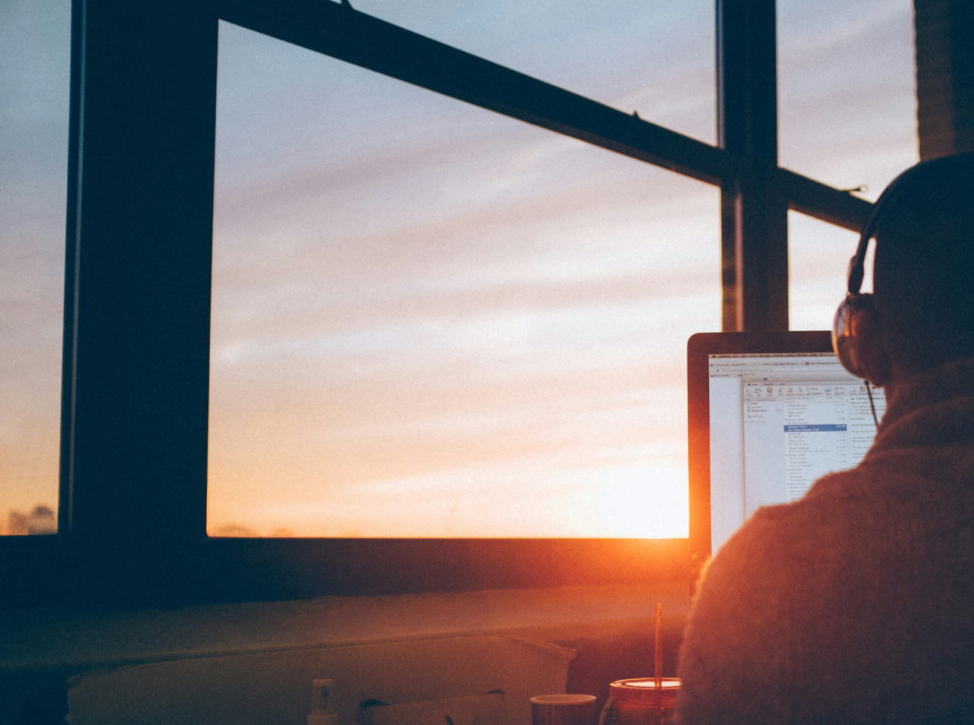 Generic photo of a person working on a computer in front of a window