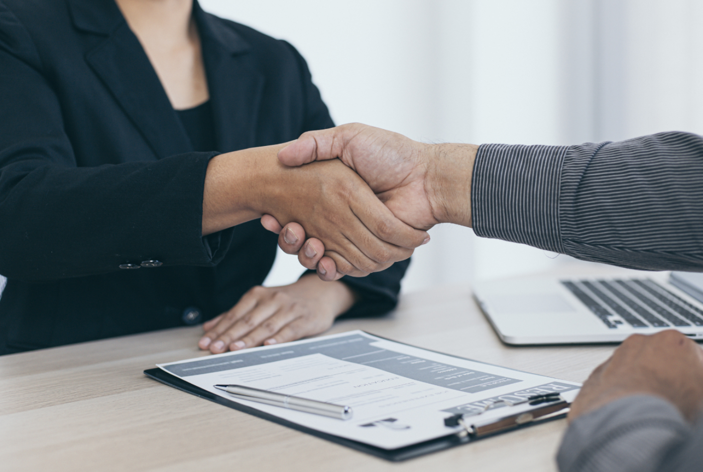 Close-up of two people shaking hands during an interview