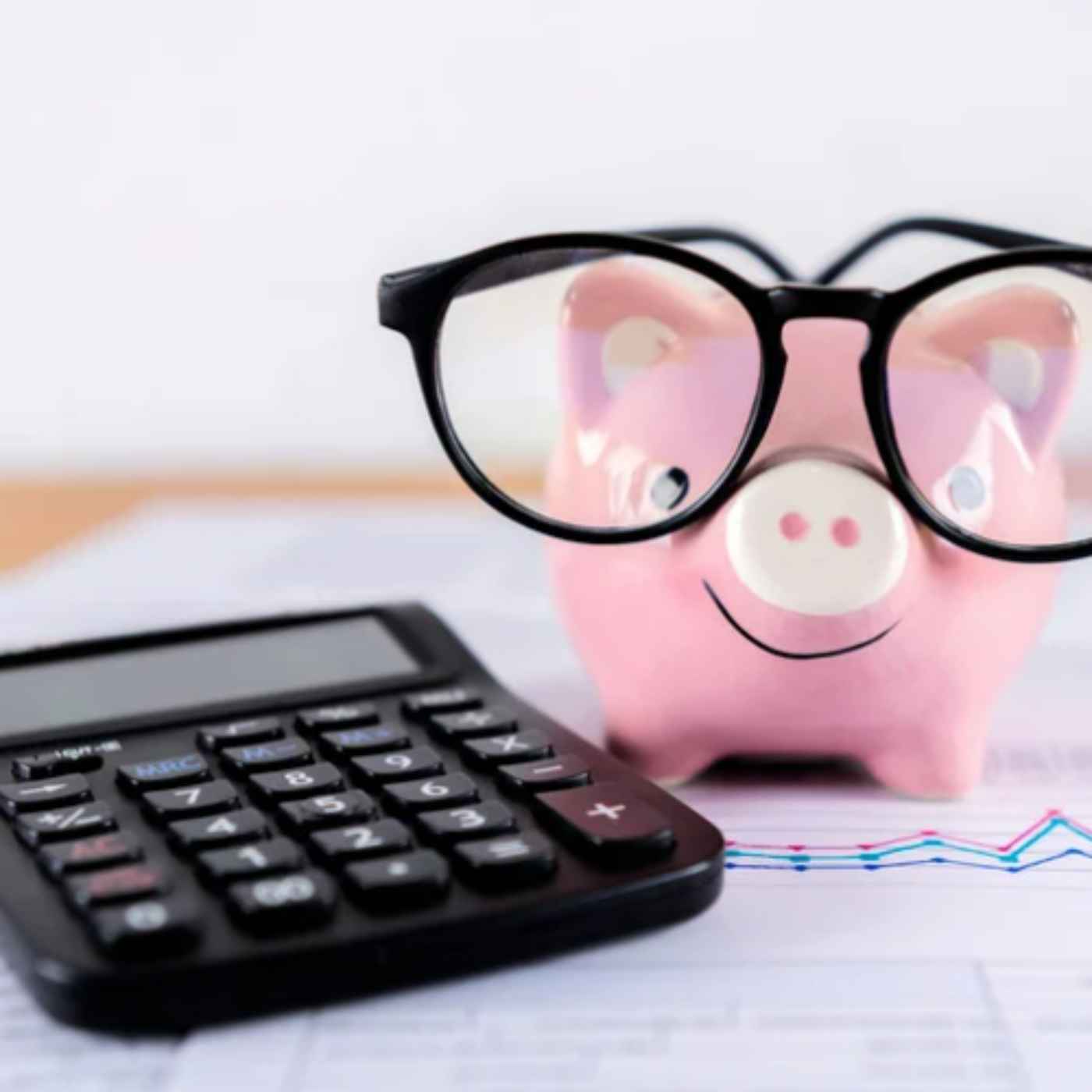Generic image of a calculator and a piggy bank wearing glasses.